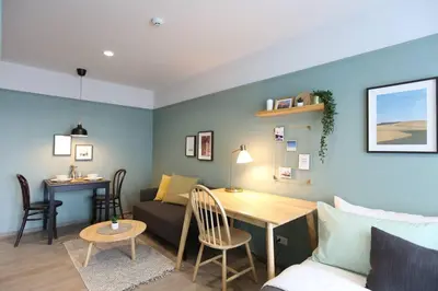 a living room with a couch and a table at WoodGreen Room near Chatuchak Weekend Market in Bangkok