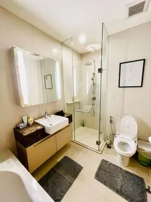 a bathroom with a sink and a toilet and a shower at Luxury 2BR on the Clouds in Prime area Bangkok in Bangkok