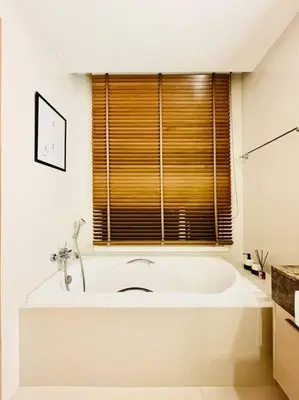 a large white tub in a bathroom with a window at Luxury 2BR on the Clouds in Prime area Bangkok in Bangkok