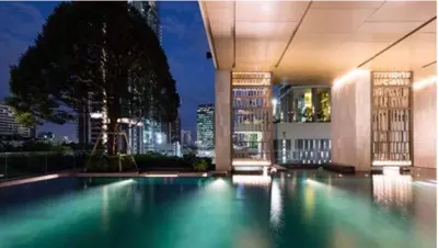 a swimming pool in a building with a city at Luxury 2BR on the Clouds in Prime area Bangkok in Bangkok