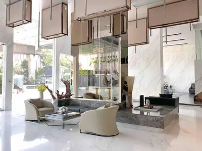 a living room with a couch and chairs in a building at 1BR Luxury Condo 50m to Thonglor BTS station in Bangkok