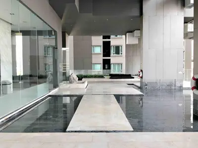 a lobby of a building with a pool of water at 1BR Luxury Condo 50m to Thonglor BTS station in Bangkok