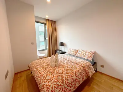 a bedroom with a bed and a window at 1BR Luxury Condo 50m to Thonglor BTS station in Bangkok