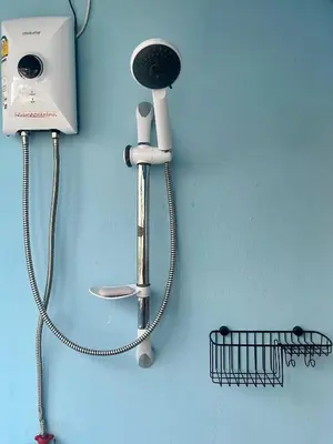 a wall with a blow dryer and a hair dryer at Doodle Lodge Bangkok in Bangkok