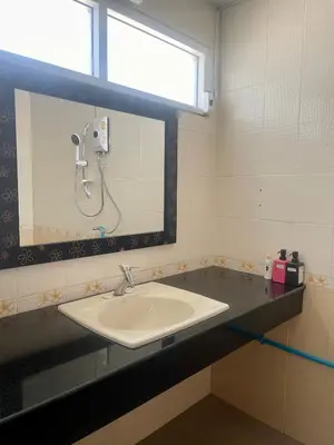 a bathroom with a sink and a mirror at Doodle Lodge Bangkok in Bangkok