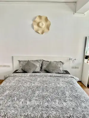 a bedroom with a bed with a black and white comforter at Doodle Lodge Bangkok in Bangkok