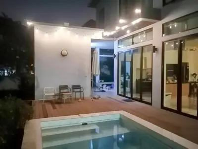 a house with a swimming pool in the yard at AP HOUSE in Bangkok