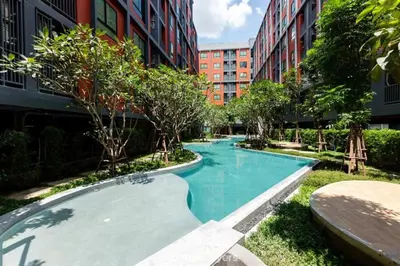 a large swimming pool in the middle of a building at Monte Rama 9 near JodFair Market in Bangkok