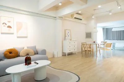 a living room with a couch and a table at 2BR minimal mu-ji style 130SQM ~ in Makkasan