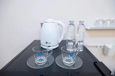 three glasses and a blender on a black table at 2BR minimal mu-ji style 130SQM ~ in Makkasan