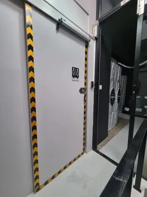 an open door with yellow and black stripes at Met A Space Pod @Phrom Phong in Bangkok