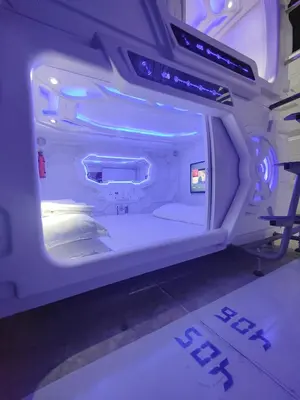 an inside view of a room with a bed in an airplane at Met A Space Pod @Phrom Phong in Bangkok
