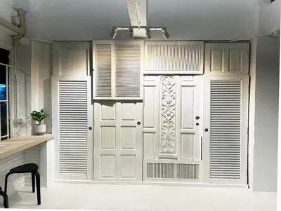 a white door in a room with a window at River Home Bangkok in Bangkok