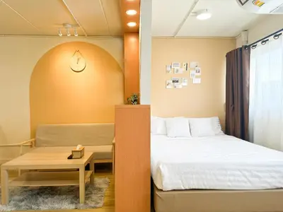 a small room with a bed and a table at Happiness Sleep in Thung Si Kan