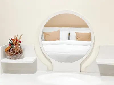 a white bedroom with a mirror and a bed at Happiness Sleep in Thung Si Kan