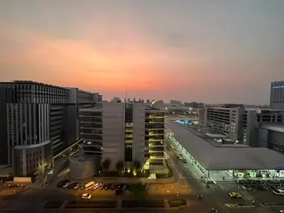 a view of a city at night with buildings at Happiness Sleep in Thung Si Kan