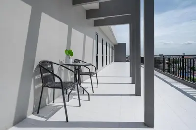 a balcony with a table and chairs on a building at iCheck inn Darisa Ngamwongwan in Nonthaburi