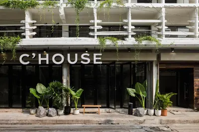 a store with plants on the front of a building at C'HOUSE Bangkok in Pom Prap