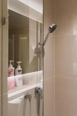 a shower in a bathroom with a mirror at 1bed room bts thonglo SuperiorSpaApartment in Ban Chaliang Khok