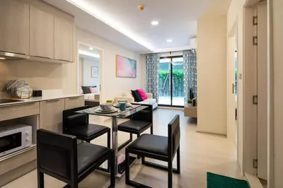 a kitchen and living room with a table and chairs at 1bed room bts thonglo SuperiorSpaApartment in Ban Chaliang Khok