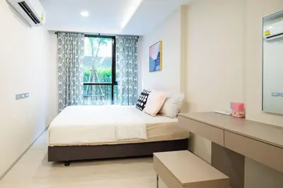 a small bedroom with a bed and a window at 1bed room bts thonglo SuperiorSpaApartment in Ban Chaliang Khok
