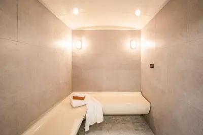 a bathroom with a bath tub and a sink at Blue Hippo & Red Crocodile Hotel in Bangna