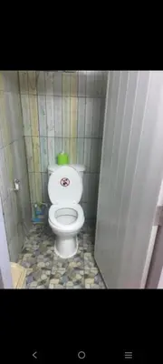 a small bathroom with a toilet in a stall at VR hostel สะพานควาย in Bang Su