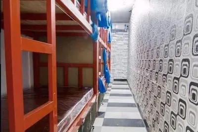 an empty room with shelves and a wall with a room with at VR hostel สะพานควาย in Bang Su