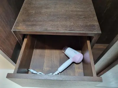 a remote control sitting in a wooden box at Tiara Place in Bangkok