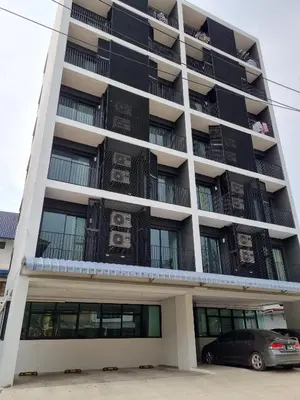 a building with a car parked in front of it at Tiara Place in Bangkok