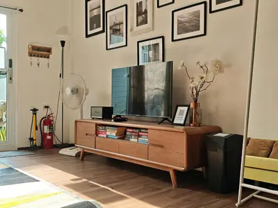 a living room with a flat screen tv on a entertainment center at Riverfront house/Chao phraya river/Baan Rimphraya in Bangkok