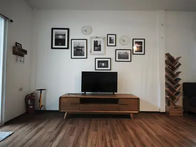 a living room with a flat screen tv on a table at Riverfront house/Chao phraya river/Baan Rimphraya in Bangkok