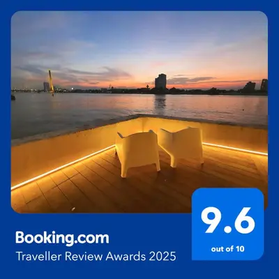 a boat with a view of the water at sunset at Riverfront house/Chao phraya river/Baan Rimphraya in Bangkok