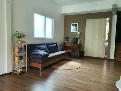 a living room with a couch and a desk at Riverfront house/Chao phraya river/Baan Rimphraya in Bangkok